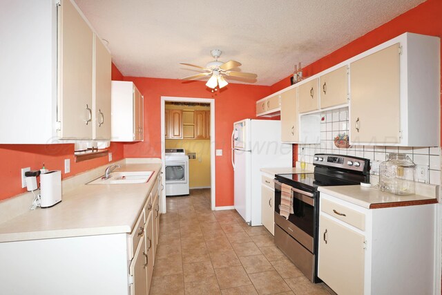 kitchen featuring electric range, backsplash, washer / clothes dryer, a sink, and a ceiling fan
