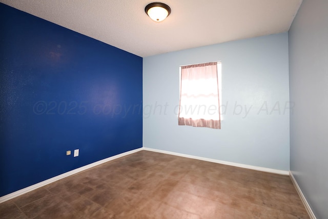 unfurnished room featuring baseboards