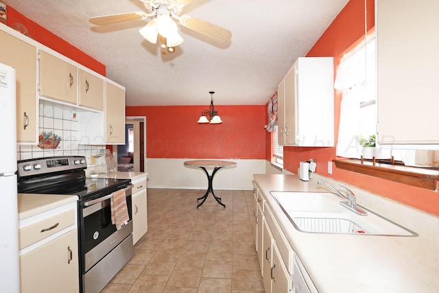 kitchen featuring light tile patterned flooring, light countertops, a sink, backsplash, and stainless steel electric stove