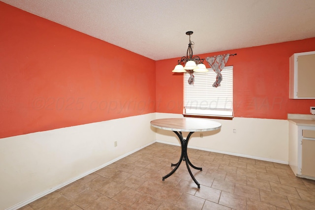unfurnished dining area with baseboards