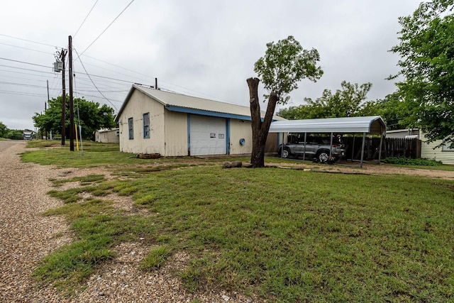 1010 E 3rd St, Clarendon, TX 79226 - back of house featuring a garage, an outdoor structure, and a carport