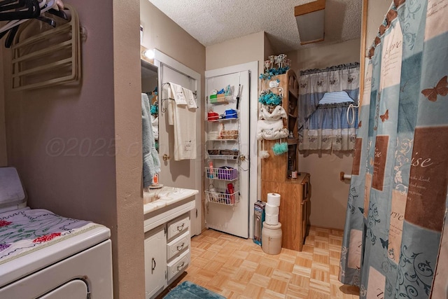 1010 E 3rd St, Clarendon, TX 79226 - full bathroom featuring a textured ceiling, vanity, and a shower with curtain