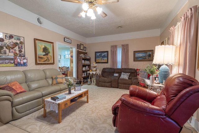 1010 E 3rd St, Clarendon, TX 79226 - carpeted living area with a ceiling fan and a textured ceiling