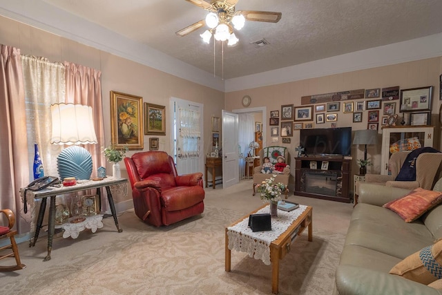 1010 E 3rd St, Clarendon, TX 79226 - living room featuring carpet, a ceiling fan, and a textured ceiling