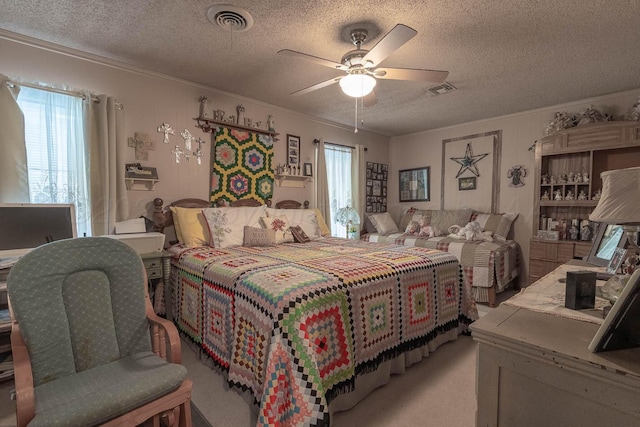 1010 E 3rd St, Clarendon, TX 79226 - bedroom featuring ornamental molding, a textured ceiling, ceiling fan, and light carpet