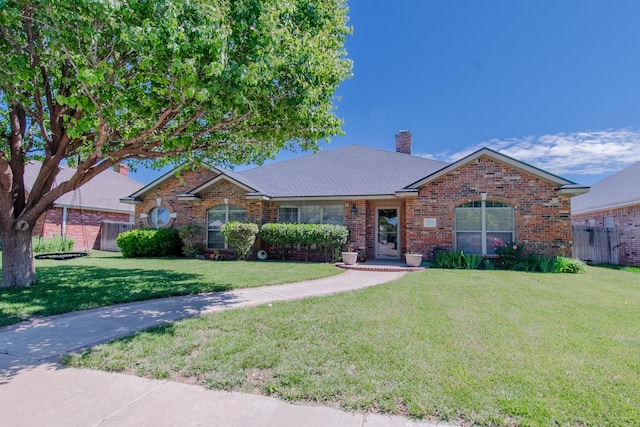 8201 Prosper Dr, Amarillo, TX 79119 - ranch-style house with a front yard, a chimney, and brick siding