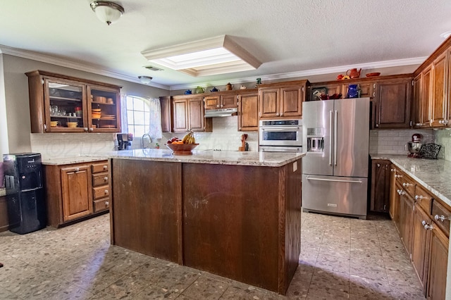 8201 Prosper Dr, Amarillo, TX 79119 - kitchen featuring stainless steel appliances, ornamental molding, under cabinet range hood, and backsplash