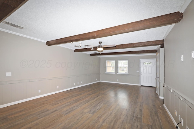 7426 Jameson Dr, Amarillo, TX 79121 - spare room with dark wood-type flooring, a ceiling fan, beamed ceiling, a textured ceiling, and a wainscoted wall