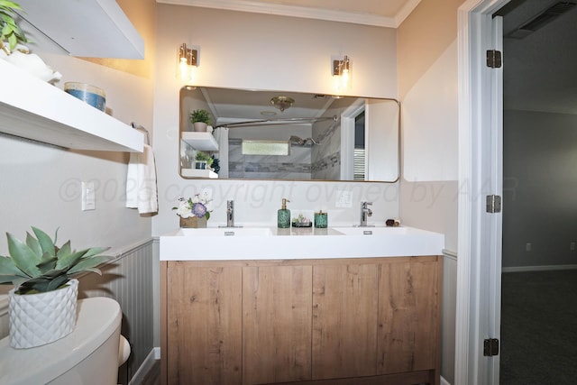 7426 Jameson Dr, Amarillo, TX 79121 - bathroom with a shower with shower door, double vanity, wainscoting, and crown molding