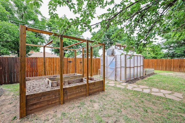 7426 Jameson Dr, Amarillo, TX 79121 - fenced backyard featuring a vegetable garden, an outdoor structure, and an exterior structure
