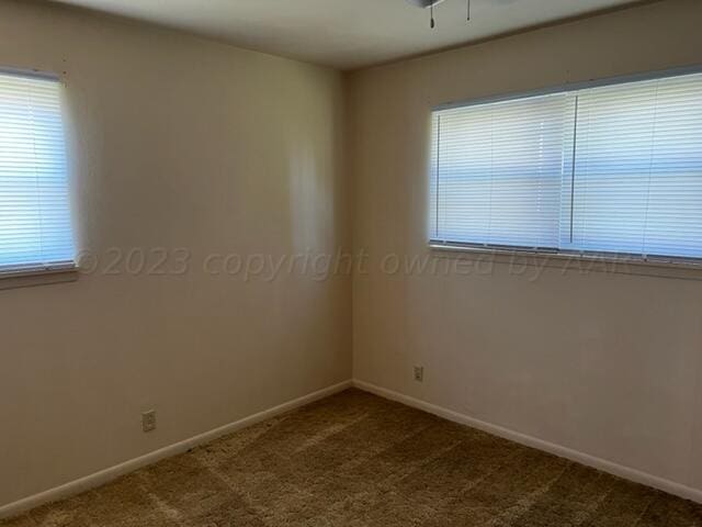 empty room with ceiling fan and carpet floors