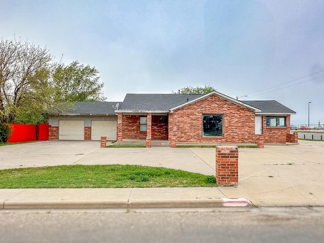600 S Mcgee St, Borger, TX 79007 - ranch-style house with concrete driveway, an attached garage, and brick siding