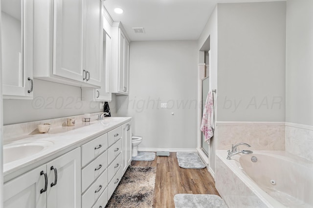 4687 E Fm 1151, Amarillo, TX 79118 - bathroom with a tub with jets, double vanity, a stall shower, and wood finished floors