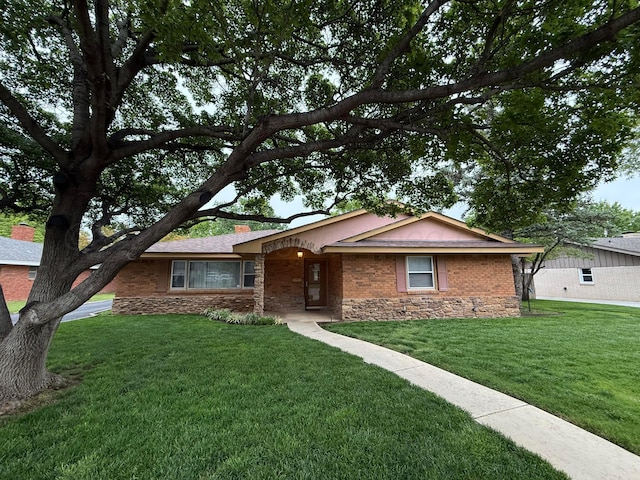 409 Thompson Ln, Canyon, TX 79015 - single story home featuring stone siding, a front lawn, and a chimney