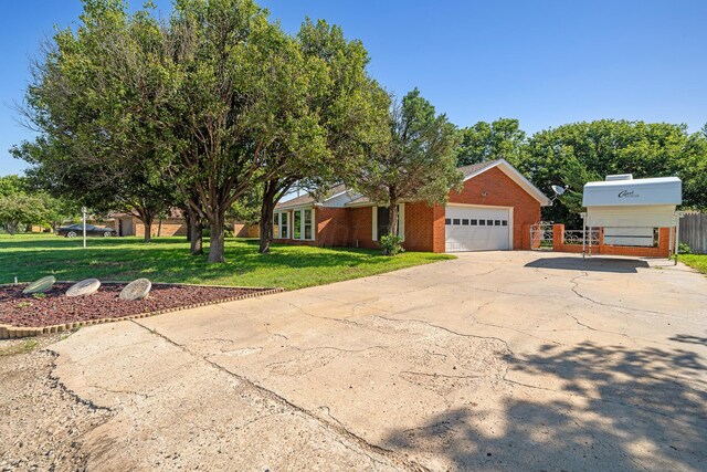 1604 Country Ln, Panhandle, TX 79068 - view of front facade with concrete driveway, brick siding, and an attached garage