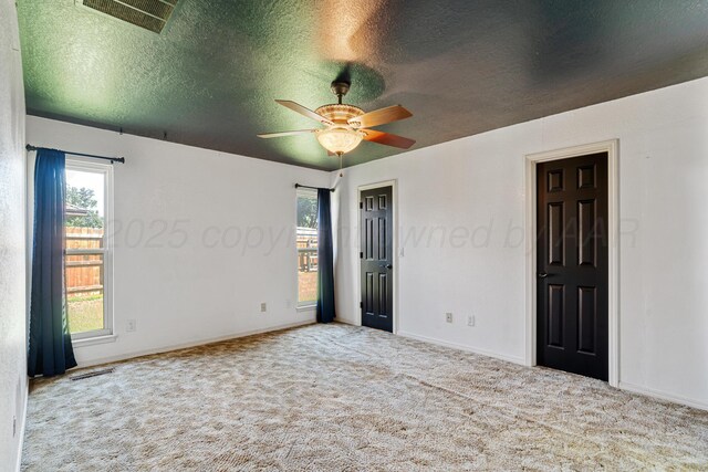 1604 Country Ln, Panhandle, TX 79068 - spare room featuring carpet flooring, a textured ceiling, and ceiling fan