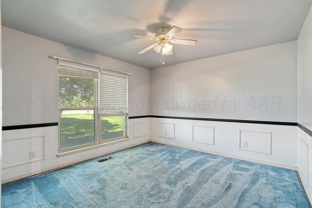 1604 Country Ln, Panhandle, TX 79068 - spare room featuring carpet flooring, ceiling fan, and a textured ceiling