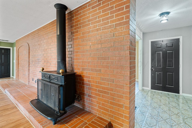 1604 Country Ln, Panhandle, TX 79068 - detailed view of a wood stove, brick wall, and a textured ceiling