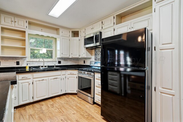 1604 Country Ln, Panhandle, TX 79068 - kitchen featuring appliances with stainless steel finishes, open shelves, tasteful backsplash, and light wood finished floors