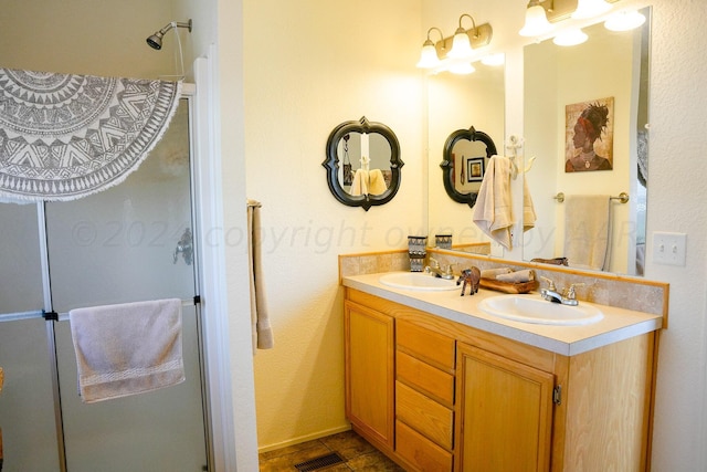 bathroom featuring vanity and a shower with shower door