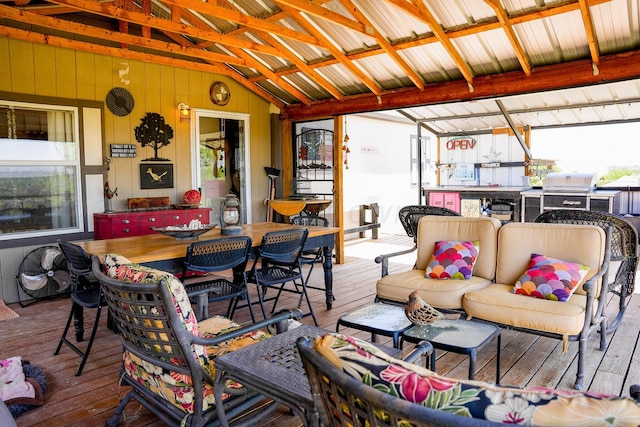 wooden terrace with an outdoor living space