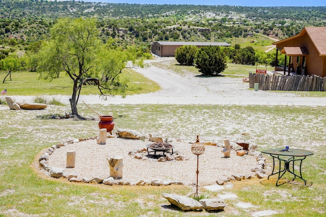 view of yard with an outdoor fire pit