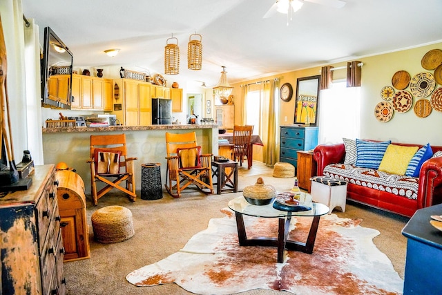 living room featuring lofted ceiling, light colored carpet, and ceiling fan