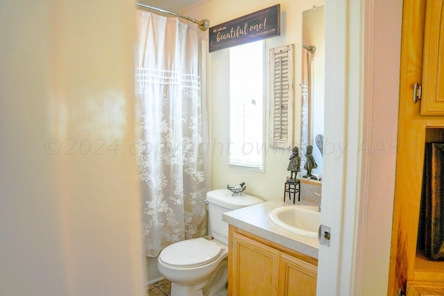 full bathroom with vanity, shower / tub combo, and toilet