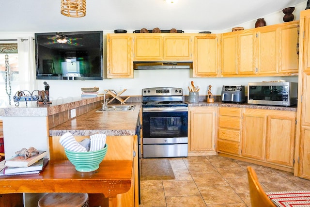 kitchen with light brown cabinetry, sink, light tile patterned floors, and appliances with stainless steel finishes