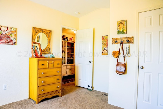 carpeted bedroom featuring lofted ceiling