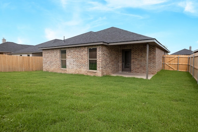 3100 Settler Ave, Amarillo, TX 79124 - back of property with brick siding, a fenced backyard, roof with shingles, and a patio area