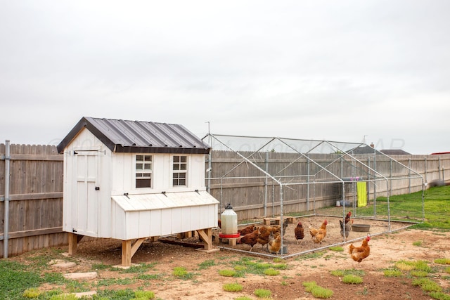 9191 E Strawberry Fields Dr, Canyon, TX 79119 - fenced backyard featuring exterior structure and an outbuilding
