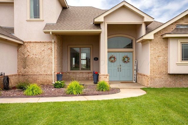 9191 E Strawberry Fields Dr, Canyon, TX 79119 - entrance to property featuring a shingled roof, stucco siding, a lawn, and brick siding