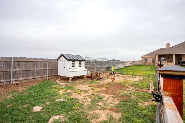 9191 E Strawberry Fields Dr, Canyon, TX 79119 - fenced backyard featuring an outdoor structure and exterior structure