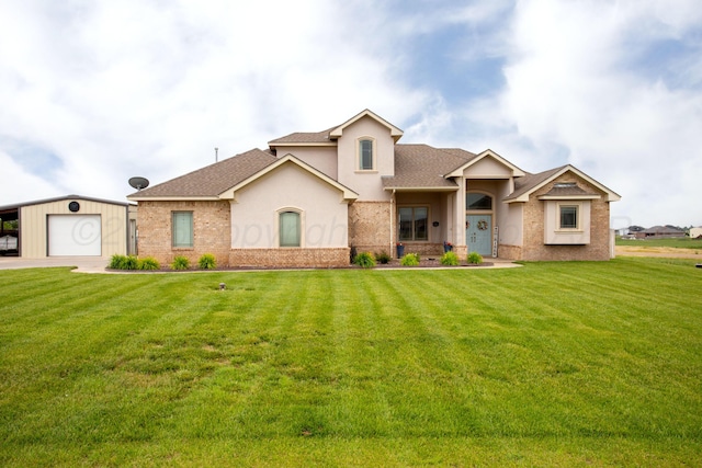 9191 E Strawberry Fields Dr, Canyon, TX 79119 - view of front of home with a shingled roof, a front yard, an outbuilding, and brick siding