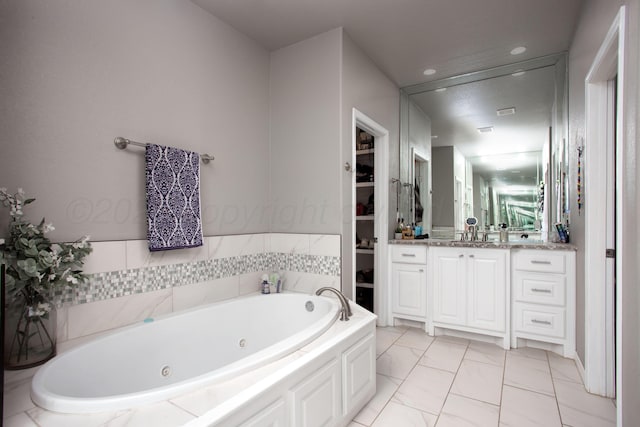 9191 E Strawberry Fields Dr, Canyon, TX 79119 - full bath featuring vanity, a tub with jets, marble finish flooring, and a walk in closet