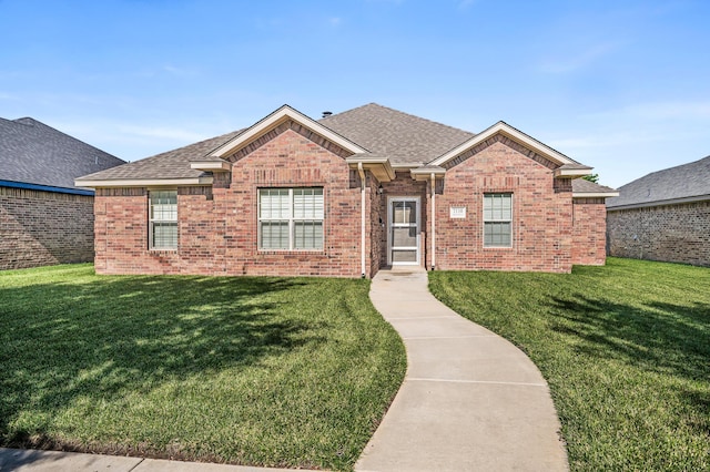 7110 Bennett St, Amarillo, TX 79119 - view of front of property featuring a front yard, brick siding, and roof with shingles