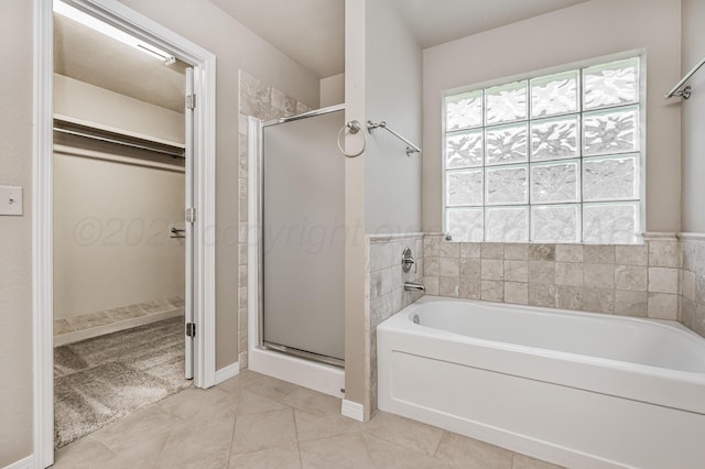 7110 Bennett St, Amarillo, TX 79119 - full bath featuring a garden tub, a stall shower, a spacious closet, and tile patterned floors