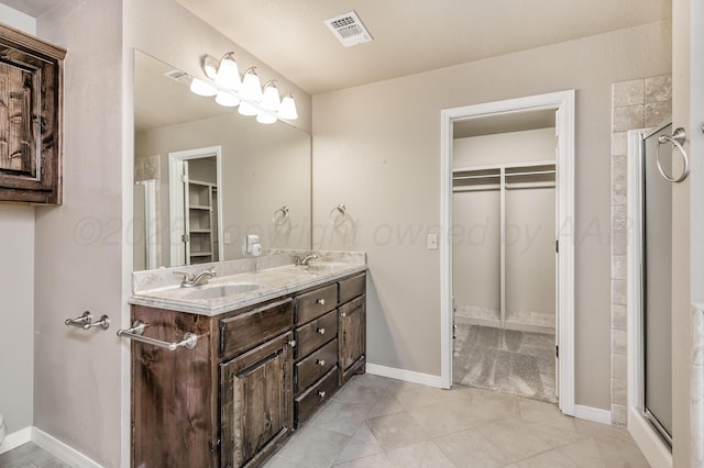 7110 Bennett St, Amarillo, TX 79119 - full bathroom featuring double vanity, tile patterned floors, and a walk in closet