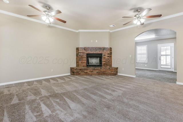 7110 Bennett St, Amarillo, TX 79119 - unfurnished living room with a ceiling fan, arched walkways, carpet, a brick fireplace, and ornamental molding