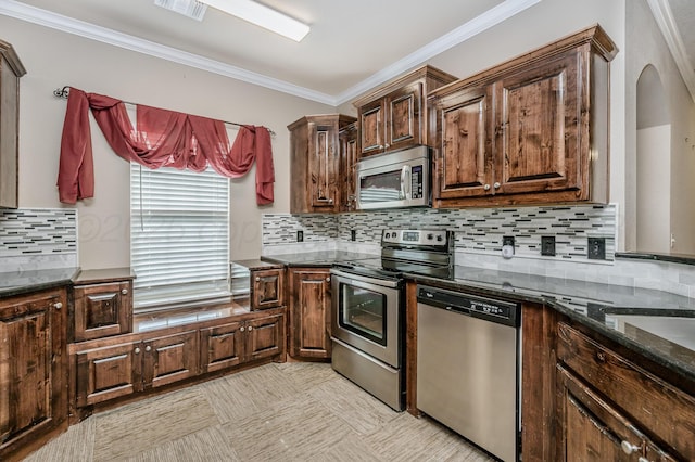 7110 Bennett St, Amarillo, TX 79119 - kitchen featuring appliances with stainless steel finishes, ornamental molding, dark stone countertops, arched walkways, and backsplash