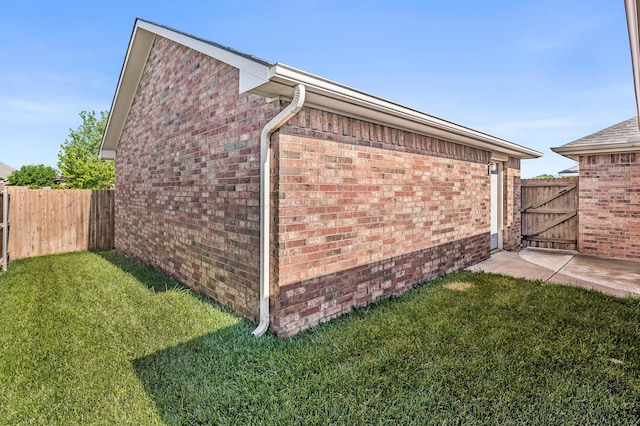 7110 Bennett St, Amarillo, TX 79119 - view of side of property with brick siding and a gate