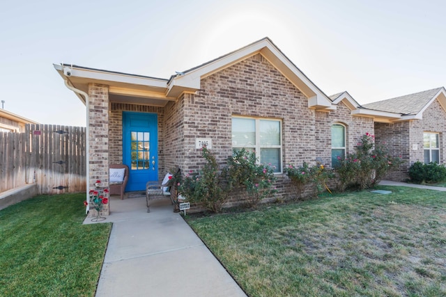 ranch-style home with a front lawn