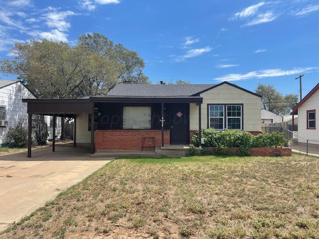 view of front facade with a front lawn and a carport