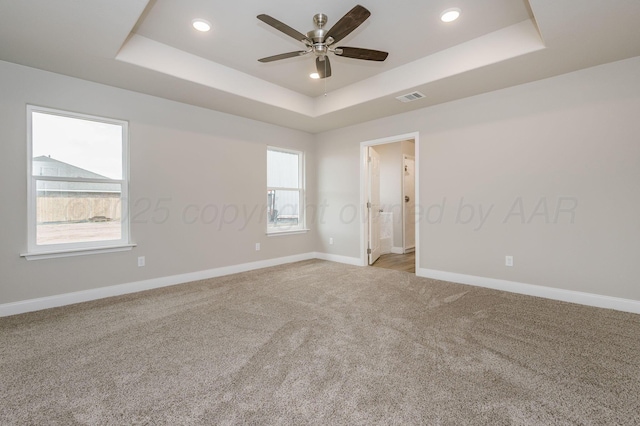 505 Pratt St, Claude, TX 79019 - unfurnished room featuring a ceiling fan, light carpet, a raised ceiling, baseboards, and visible vents