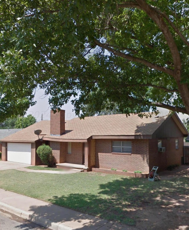 ranch-style house featuring a garage and a front yard