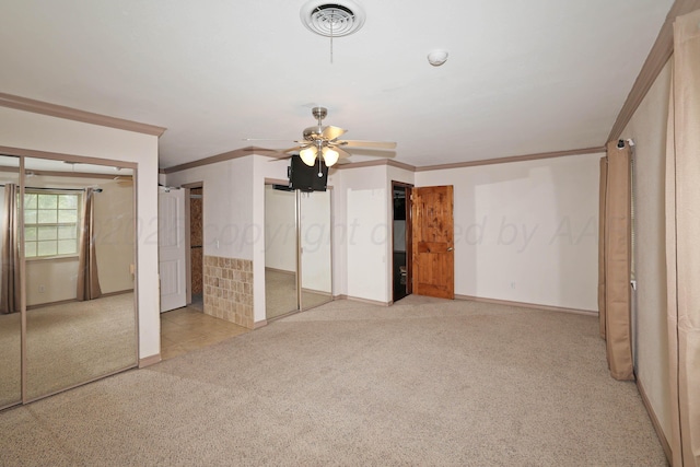 5507 Harvard St, Amarillo, TX 79109 - unfurnished bedroom featuring light carpet, ornamental molding, baseboards, multiple closets, and ceiling fan