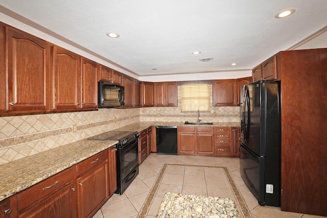 5507 Harvard St, Amarillo, TX 79109 - kitchen with black appliances, a sink, light stone counters, tasteful backsplash, and recessed lighting