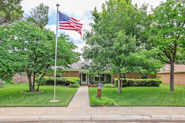 5507 Harvard St, Amarillo, TX 79109 - view of front of property with a front yard and brick siding
