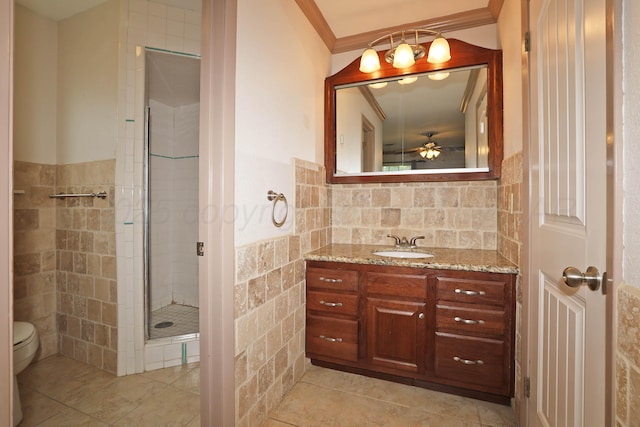 5507 Harvard St, Amarillo, TX 79109 - bathroom with toilet, tile walls, vanity, tile patterned flooring, and a shower stall